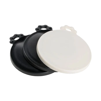 Three pet food bowl lids in black and white, featuring a paw print design on the handles for easy lifting.