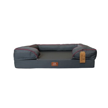 Gray rectangular dog bed with raised bolsters, red piping and hex pattern, leather tag reading "Beddies".