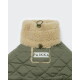 Olivgrüner, gesteppter Tiermantel mit cremefarbenem Sherpa-Kragen, Knebelverschlüssen und Markenlabel 'PAIKKA'.