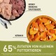 Bild von Zutaten für Haustierfutter mit rohem Hähnchen, Hering und Kürbis. Der Text hebt "65% Zutaten von kleinen Futtertieren" hervor.