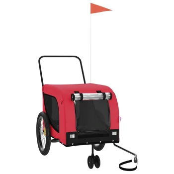 Roter Haustieranhänger mit einer schwarzen Netzfront, zwei großen Rädern, einem kleinen Vorderrad und einer orangefarbenen Sicherheitsflagge.