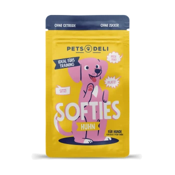 Emballage de friandises pour chiens "Pets Deli Softies" coloré avec un chien rose en dessin animé et le texte : "Idéal fürs Training," "Huhn," et "Für Hunde."