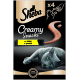 Emballage de Sheba Creamy Snacks présentant un chat gris allongé, avec une étiquette jaune indiquant "mit Huhn au poulet" et "x4" indiquant quatre portions.