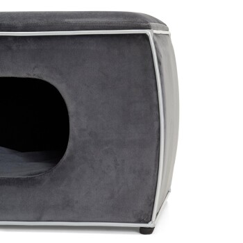 Graues Haustierbett mit einem gemütlichen, höhlenartigen Eingang, das eine weiche Oberfläche und abgerundete Kanten bietet.