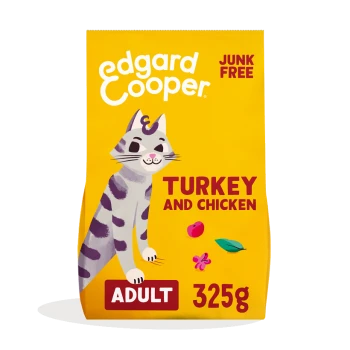 Yellow cat food bag featuring a playful illustrated cat, labeled "Turkey and Chicken," "Adult," and "325g," with "Junk Free" prominently displayed.