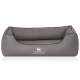 Graues Hundebett mit einem gesteppten Design und einem Logo eines Hundesilhouetten, beschriftet mit "KNUFFELWUFF."