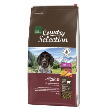 Country Selection Trockenfutter Hund, Junior, Alpine, Truthahn und Alpenrind 12 kg Hundefutterbeutel "Real Nature Country Selection - Alpine" mit einem Hund in den Bergen, der Truthahn, alpines Rindfleisch, Käse und Kürbis enthält. 12 kg.