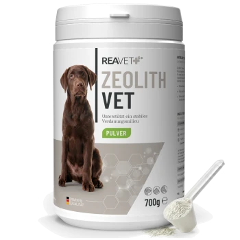 Weißer Behälter mit der Aufschrift 'REAVET ZEOLITH VET PULVER 700g', zeigt ein Bild eines braunen Hundes und eine Schaufel mit weißem Pulver.