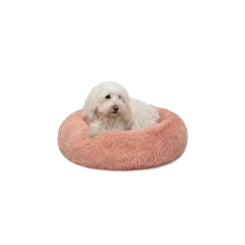 Ein flauschiger weißer Hund ruht sich in einem runden, weichen, rosa Haustierbett aus, das ein gemütliches und komfortables Design zeigt.