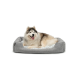 Ein flauschiger, glücklicher Siberian Husky liegt bequem auf einem grauen Haustierbett mit einem weichen, gemusterten Innenraum.