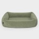 Grünes Plüschhaustierbett mit erhöhten Rändern, das eine weiche, gemütliche Textur aufweist, ideal für kleine bis mittelgroße Haustiere.