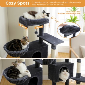 Mehrstöckiger grauer Katzenbaum mit einer oberen Plattform, Hängematte und Wohnung. Zwei Katzen entspannen: eine getigerte in der Hängematte und eine flauschige weiße Katze darin.