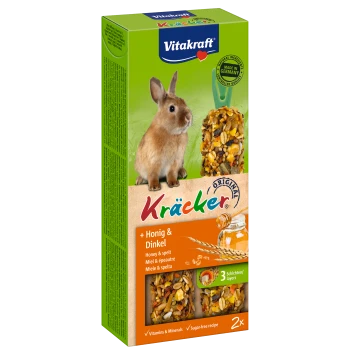 Vitakraft Kräcker für Kaninchen, mit einem braunen Kaninchen neben einem Honig- und Dinkel-Leckerli, beschriftet mit "Vitamins & Minerals" und "Zuckerfreies Rezept."