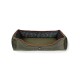 Olive green dog bed with a quilted design and black camouflage interior, featuring orange piping and a logo patch.