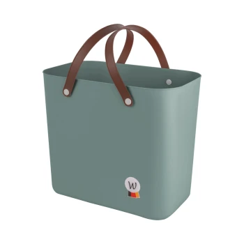 Ein stilvoller, mintgrüner Haustieraufbewahrungskorb mit braunen Griffen und einem kleinen Logo mit einem 'W' an der Seite.