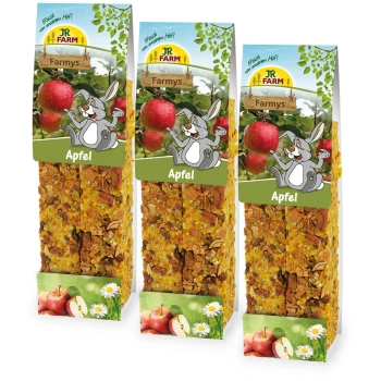 Trzy opakowania przysmaków jabłkowych JR FARM Farmys dla zwierząt, z graficznym wizerunkiem wesołego królika i obrazkami jabłek.
