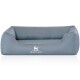 Graues Hundebett mit niedrigem Rücken und hohen Seiten, mit dem "Knuffelwuff"-Logo auf der Vorderseite.