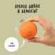 Eine Person hält einen orangefarbenen Haustier-Spielball mit einem Kronenlogo, mit dem Text "Ideale Größe & Gewicht" und den Maßen 6,5 cm und 170 g.