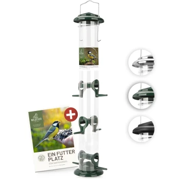 Futtersäule für Samen, Körner & Kerne 52cm, Grün Transparenter Vogelhäuschen mit grünen Akzenten, mit mehreren Futteröffnungen und einem Aufhängehaken, neben einem Werbebroschüre.