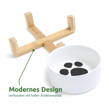 Moderne Haustierschüssel mit einem Bambusständer, mit einem Pfotenabdruckdesign im Inneren der Schüssel. Der Text lautet "Modernes Design verbunden mit hoher Funktionalität."