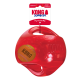 Jouet KONG Jumbler rouge pour chien contenant une balle de tennis, avec étiquette commerciale indiquant 'KONG JUMBLER' et 'Dogs Need to Play'.