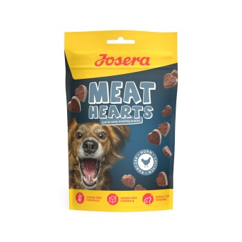 Josera Meat Hearts Hundeleckerli-Tüte mit begeistertem Hund und herzförmigen Snacks; Aufschrift: 'Weiche und schmackhafte Trainingssnacks'.