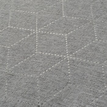 A close-up of a textured gray fabric featuring a hexagonal pattern with white stitching.