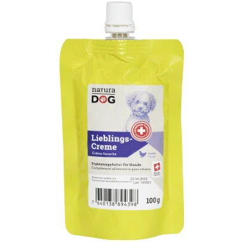 Gelber Beutel mit 'natura DOG Lieblings-Creme' Hundesupplement, mit einer Hundillustration, Nährwertinformationen und einem Barcode.