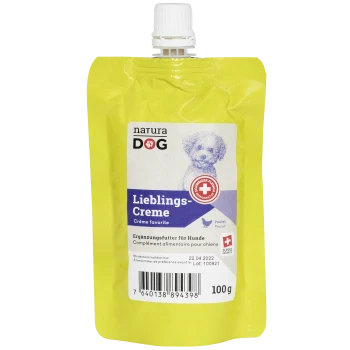Gelber Beutel mit 'natura DOG Lieblings-Creme' Hundesupplement, mit einer Hundillustration, Nährwertinformationen und einem Barcode.