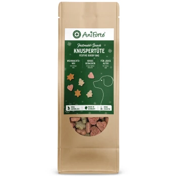 Eine festliche Tüte mit Hundeleckerlis in einer braunen Papierverpackung, mit einem grünen Etikett mit Text in deutscher Sprache und Bildern von stern- und herzförmigen Keksen.