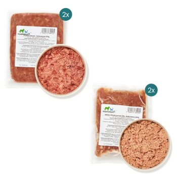 Zwei Pakete rohen Tierfutters mit der Aufschrift "Wolfer-Rinderpansen-Mix, Nettomasse 500g" mit einer Schüssel des Produkts in der Mitte.