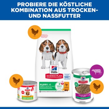 Hill's Science Plan Welpenbeutel mit zwei Beagles und zwei Nassfutterdosen; sichtbarer Text ‚PUPPY <1‘ und deutsche Überschrift.