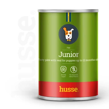 Grüne Dose Husse Junior Welpenpastete mit Kalbfleisch, gekennzeichnet für Welpen bis zu 12 Monaten, mit Immunitätsunterstützung und ohne künstliche Aromen.