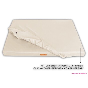 Ein cremefarbenes Haustierbett mit einem abnehmbaren Bezug, teilweise geöffnet, das eine weiche Oberfläche und ein Etikett an der Seite zeigt.