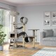 Een moderne kattenboom met meerdere niveaus, tunnels en een hangmat, met twee speelse tabby katten. Helder woonkamer setting.