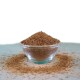 Eine klare Glasschüssel gefüllt mit einem feinen, braunen Nahrungsergänzungsmittel-Pulver, umgeben von einem kleinen Haufen des Pulvers auf einer hellen Oberfläche.