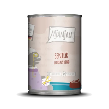 Eine Dose Mjamjam Senior Hundefutter mit einem Cartoon-Hund in einem lila Outfit. Text: "Senior Leckeres Rind" für Senioren-Hunde, mit Rindfleischgeschmack.