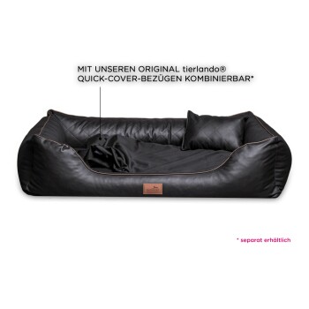 Schwarzes Haustierbett mit einem gesteppten Innenraum, mit einem kleinen Kissen und einem lederähnlichen Äußeren, beschriftet mit einem Markenschild.