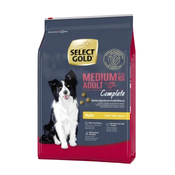 Hundefutterbeutel mit einem schwarz-weißen Hund, beschriftet mit "SELECT GOLD MEDIUM ADULT Complete", mit Details zu Gewicht und Zutaten.