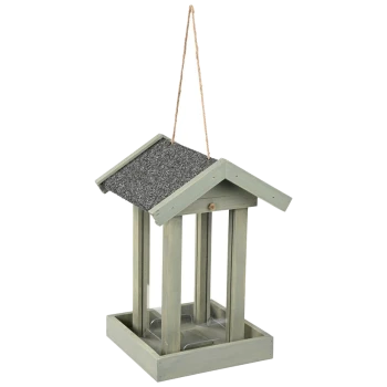 Hanging wooden bird feeder with a sloped roof and open design, featuring a light green finish and a textured black top.