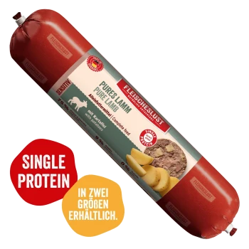 Fleischeslust-Holzfutterbox und rote Futterrolle mit der Aufschrift 'Pures Lamm / Pure Lamb' und 'Natürlich & Artgerecht'.