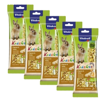 Five packages of Vitakraft Kräcker for rabbits, featuring popcorn and honey, with a rabbit image and text highlighting vitamins and minerals.
