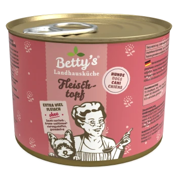Eine Dose Betty's Landhausküche Hundefutter, "Fleischtopf," mit einem pinken Design, das eine Frau, einen Hund und den Text "extra viel Fleisch" zeigt.