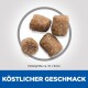 Vier braune Haustierfutterpellets, etwa 10x9mm groß, auf einem weißen Hintergrund mit dem Text 'KÖSTLICHER GESCHMACK' darunter.