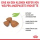 Welpenfutter-Kroketten in dreieckiger Form, mit dem Text: "Eine an den kleinen Kiefer von Welpen angepasste Krokette", und Angaben zu Inhaltsstoffen.