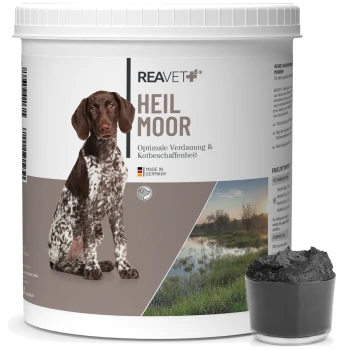 Behälter mit Reavet Heilmoor für Hunde, mit dem Etikett "Optimale Verdauung & Kotbeschaffenheit," neben einem kleinen Schälchen mit schwarzer Substanz.