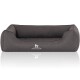 Ein graues Hundebett mit erhöhten Seiten und einem weichen Kissen, mit dem Logo "KNUFFELWUFF" auf der Vorderseite.