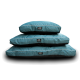 Three stacked teal dog beds with black bottom, white piping and 'Beddies' logo label