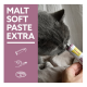 A gray cat sniffs a tube labeled "MALT SOFT PASTE EXTRA" held by a person. Icons depict application methods and a food bowl.