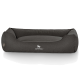 Ein dunkelgraues Hundebett mit erhöhten Seiten und einer weichen Mitte, mit dem Logo "KNUFFELWUFF®" deutlich sichtbar.